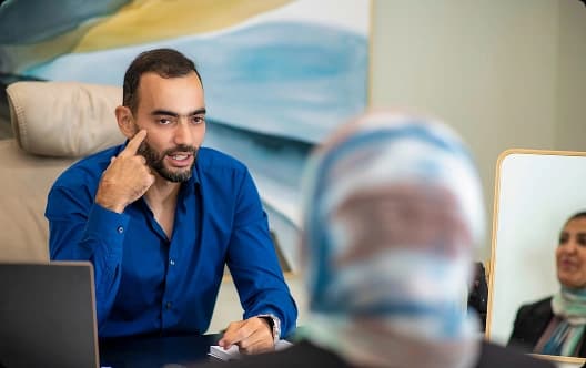 Dr. Mohamed El Nazer listening to a patient in the clinic